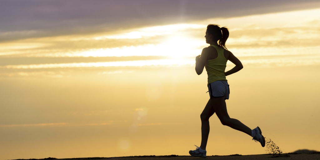 Athlete running at sunset on beach